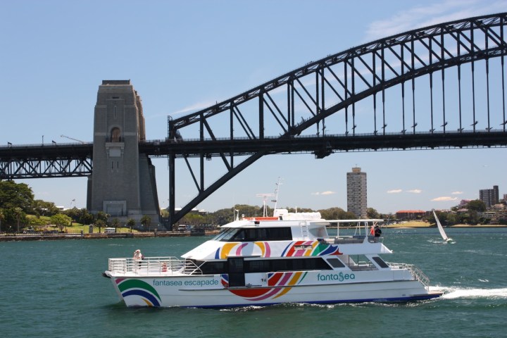 a boat traveling across a bridge over a body of water